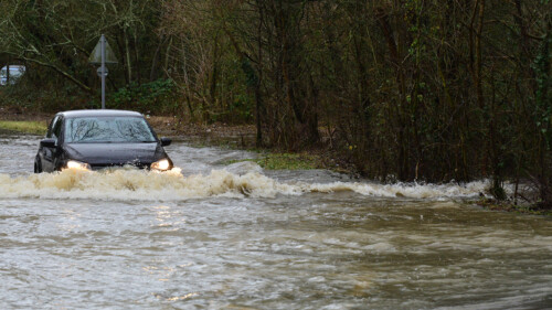 car passing through floodwater