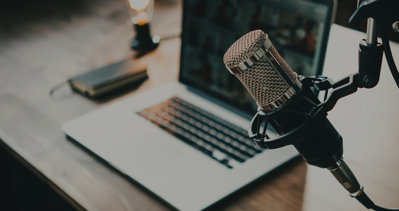 close-up of microphone and laptop at desk