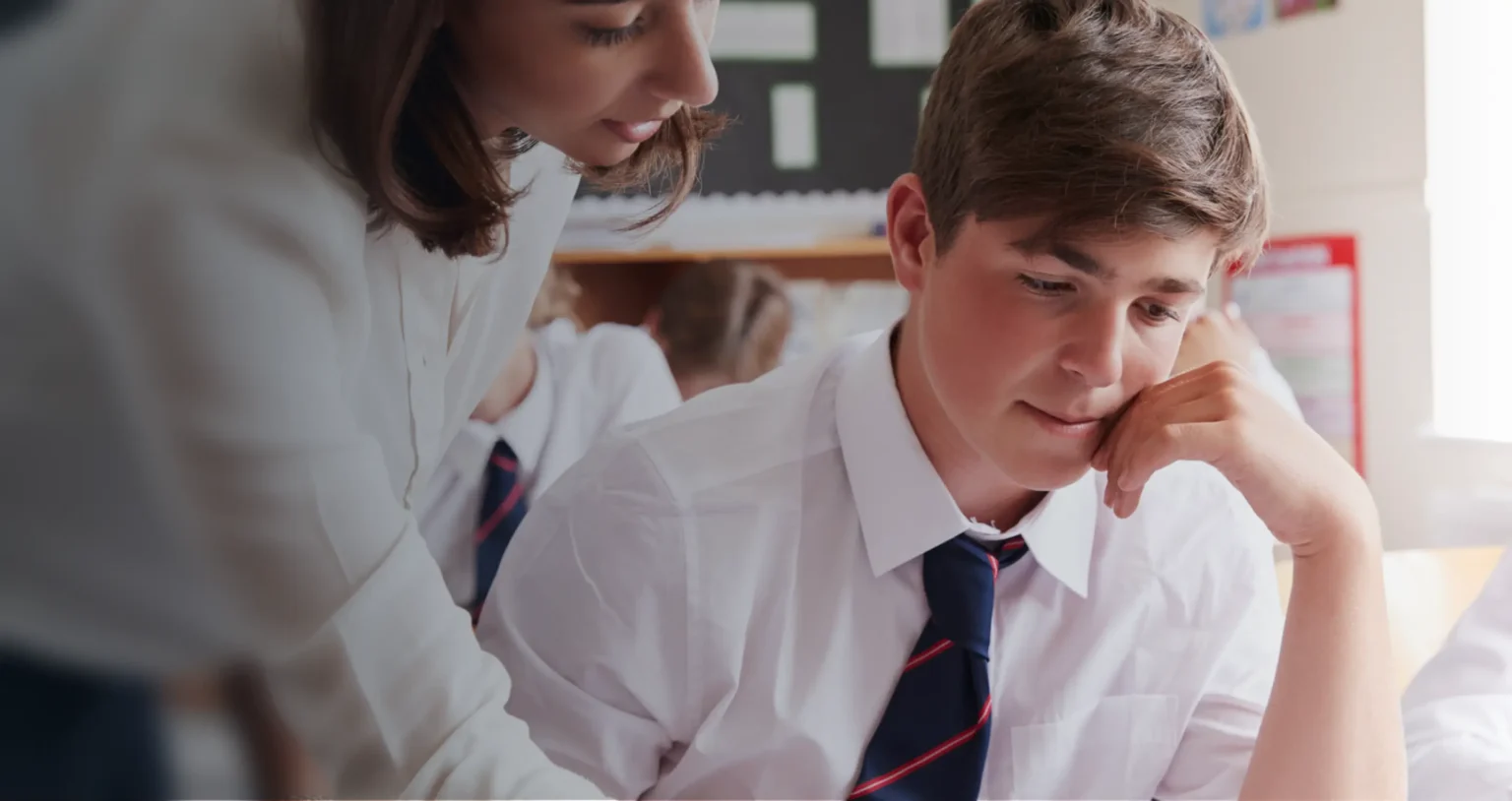 teacher guiding student in classroom