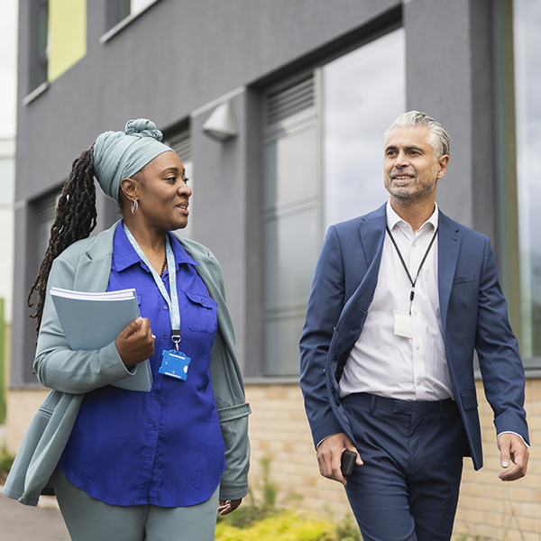 two teachers walking in school grounds